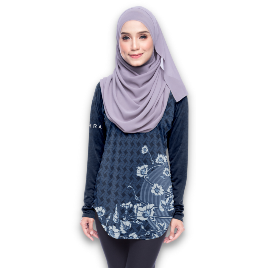 A woman wearing a lilac hijab, midnight blue top and black pants.